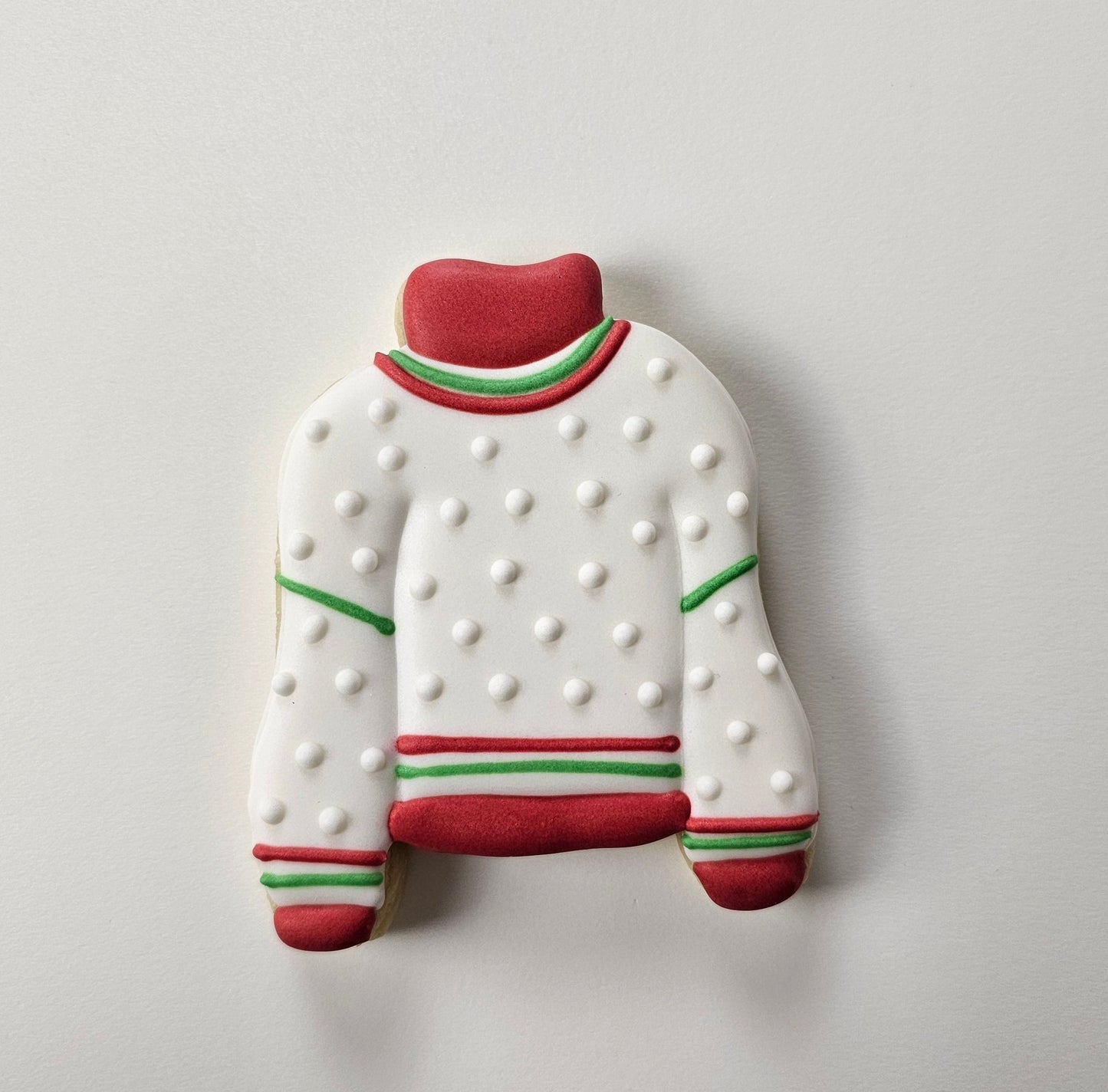 Decorated sugar cookie that looks like a Christmas sweater