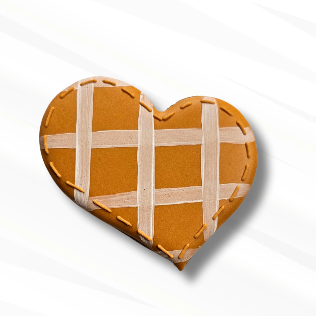 Cozy heart shaped sugar cookie with a white plaid pattern