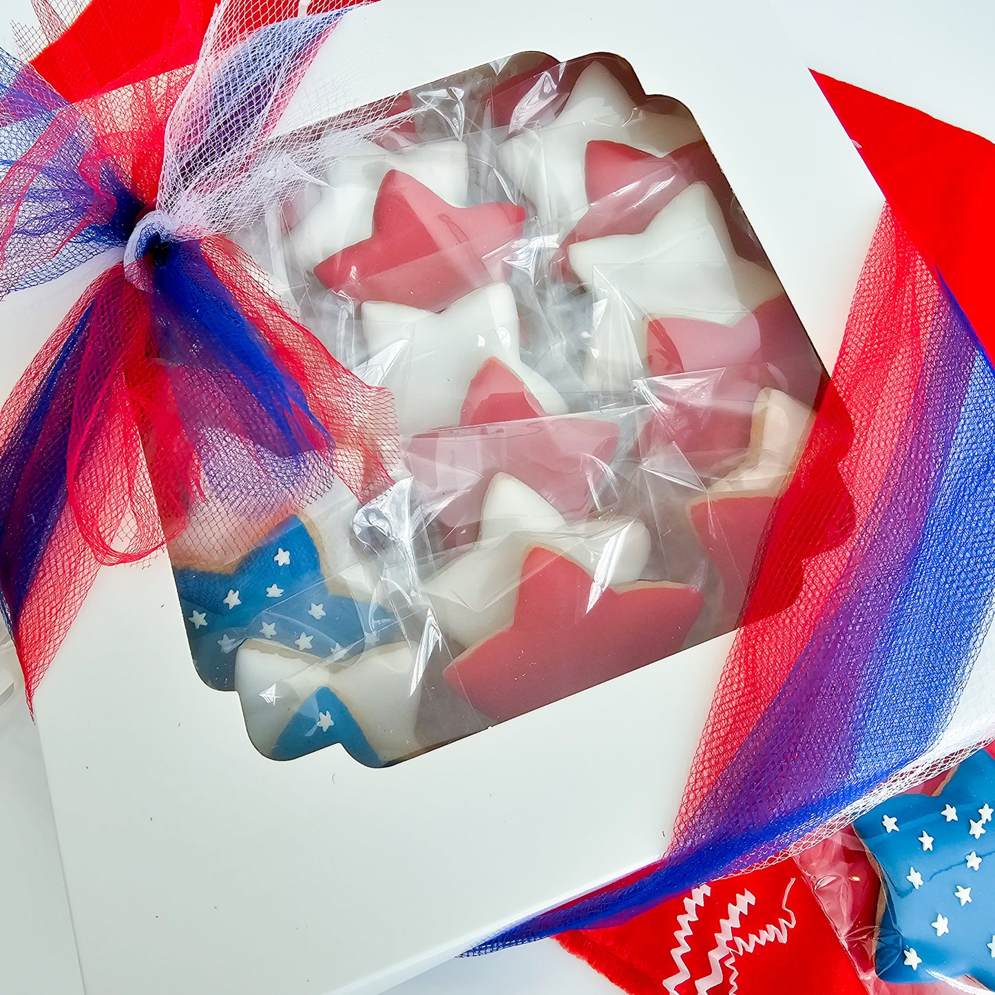 Red white and blue star shaped sugar cookies in a gift box