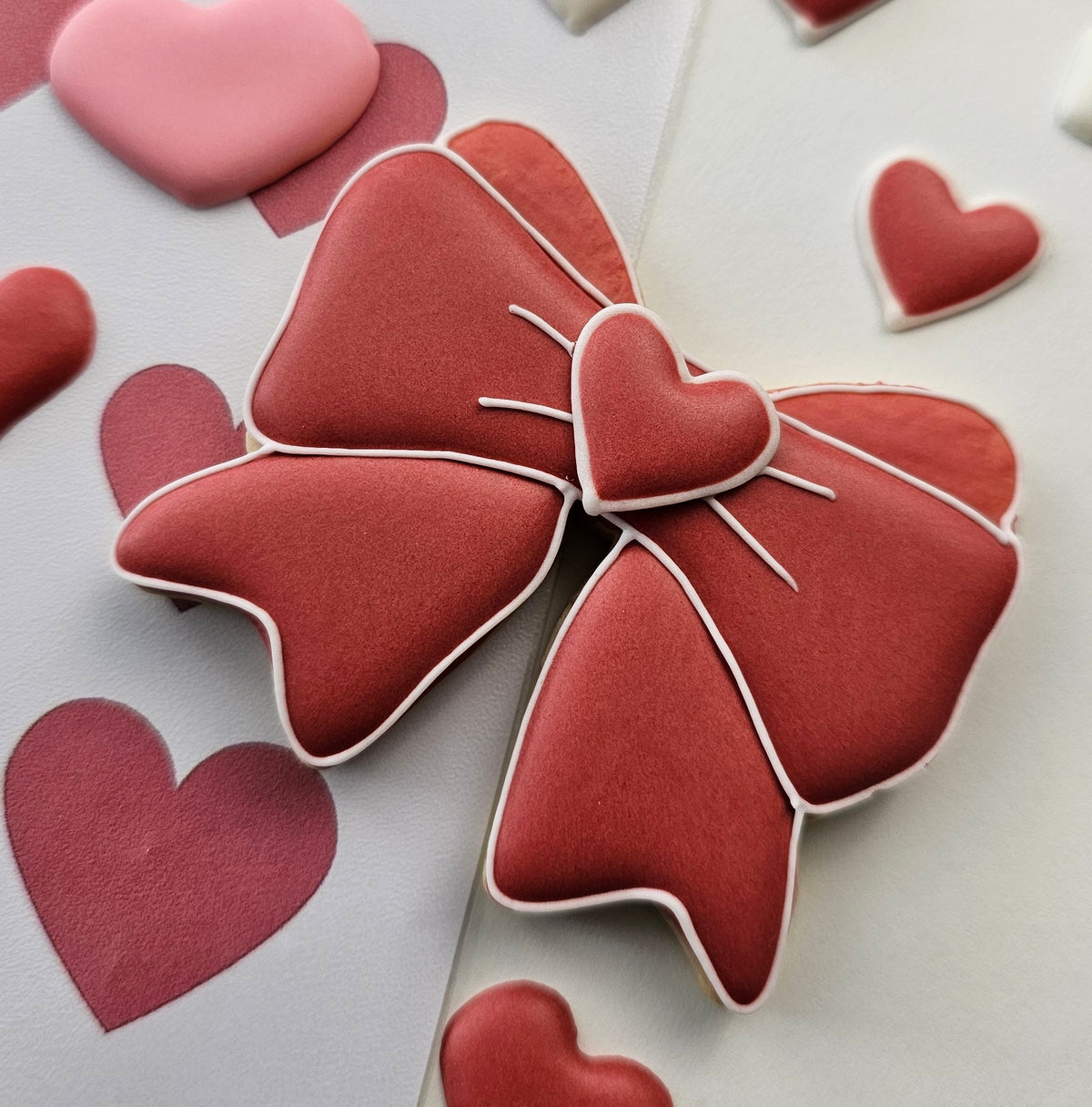 Bow sugar cookie with a heart royal icing transfer