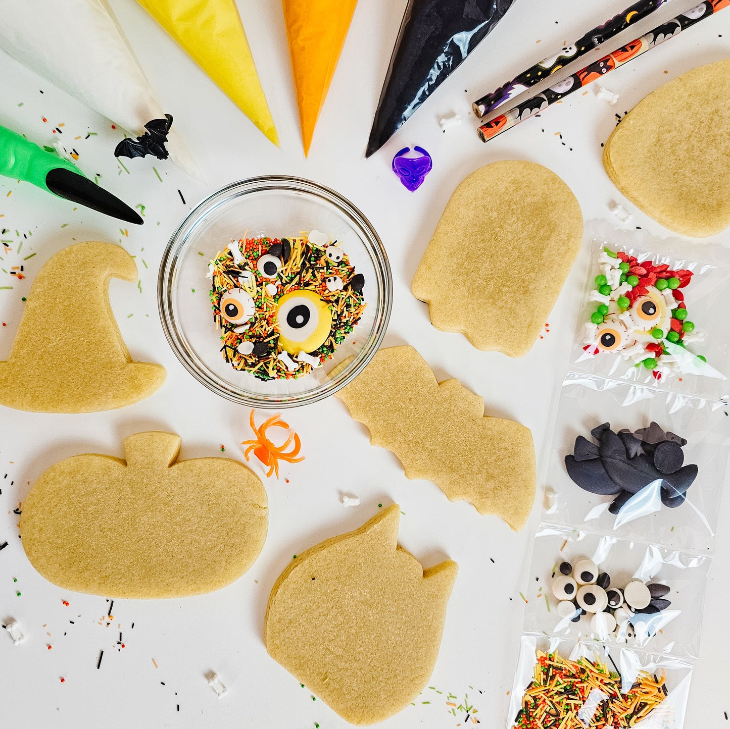 Halloween sugar cookies ready to be decorated, sprinkles and royal icing