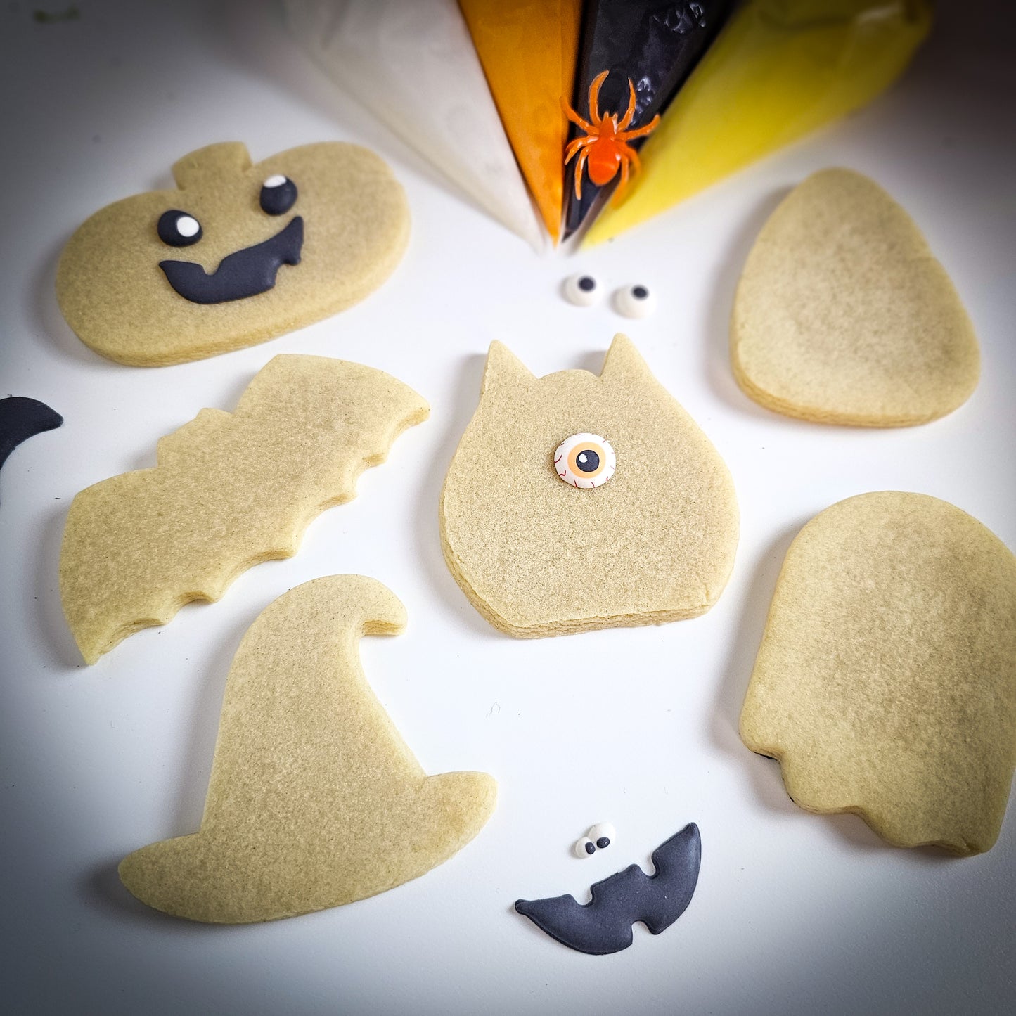 Halloween sugar cookies ready to be decorated with funny sprinkle faces