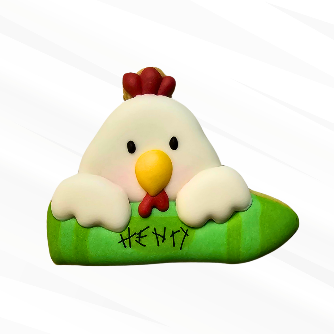 Chicken holding a green crayon sugar cookie