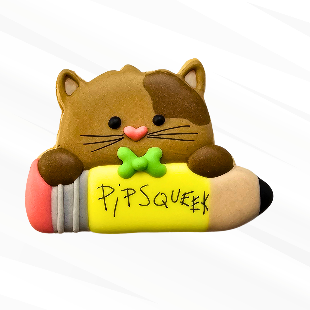 Cat holding a pencil decorated sugar cookie