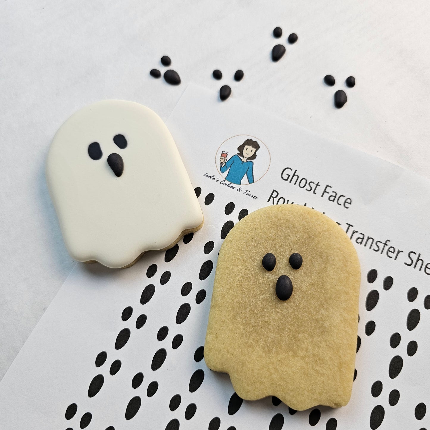 Ghost sugar cookies with royal icing transfers for the eyes and mouth