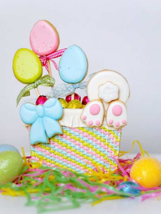 3D Easter basket cookie with sugar cookie eggs, a bunny butt, and a pretty blue cookie bow.