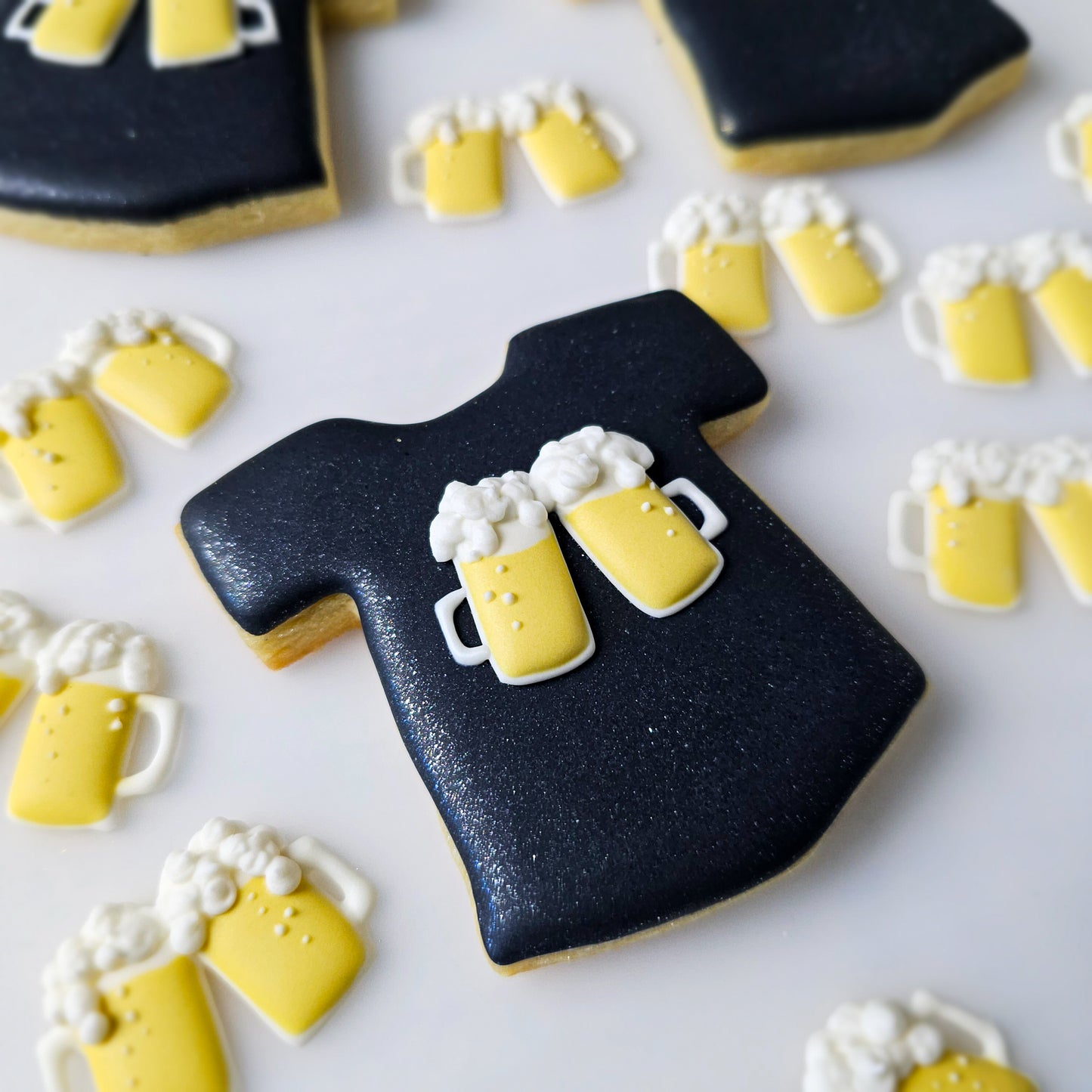 Black T-shirt sugar cookie with beer mugs royal icing transfers 