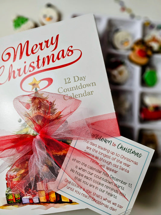 Merry Christmas 12 Day cookie Countdown Calendar with red ribbon and blurred gift boxes in the background