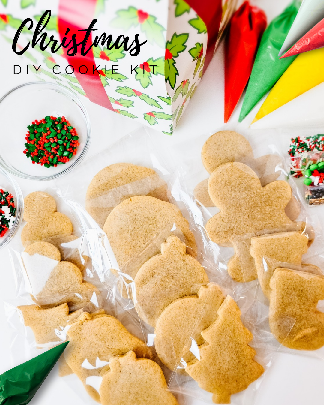 Christmas DIY cookie kit with gingerbread cookies and decorating supplies on a white surface.