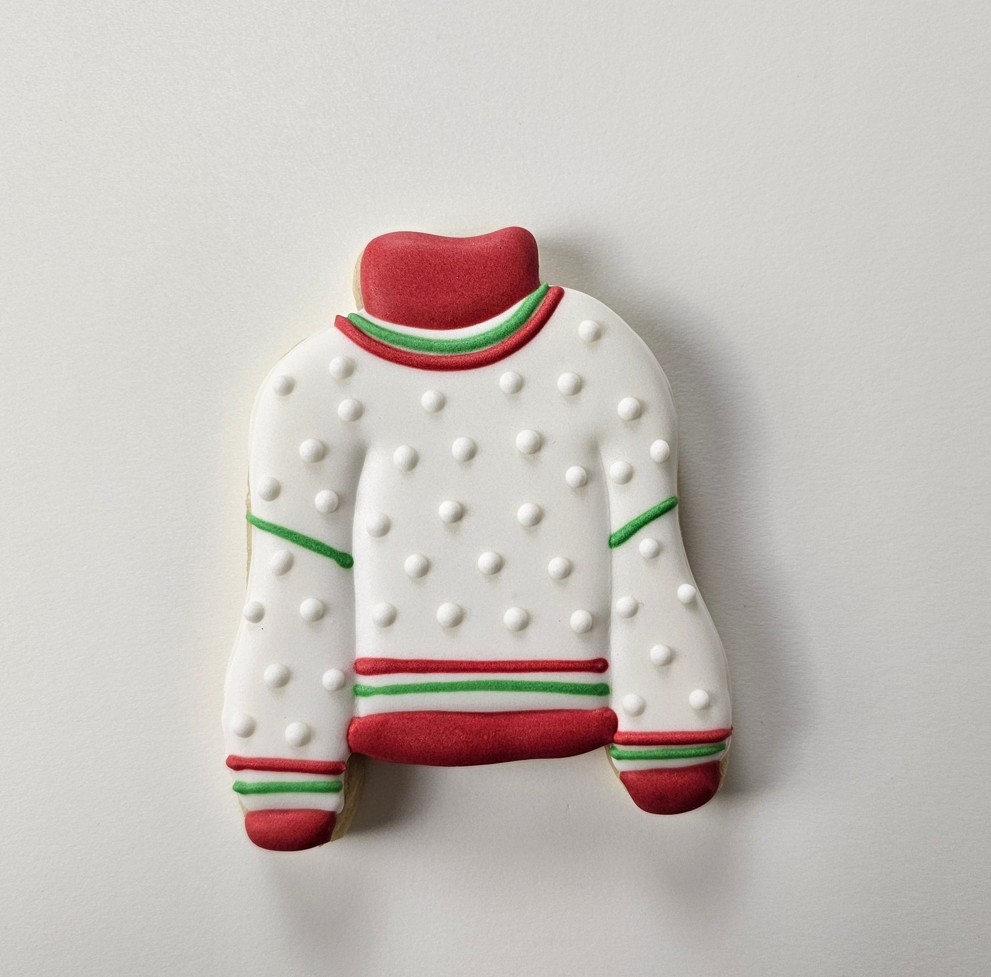 Decorated sugar cookie that looks like a Christmas sweater