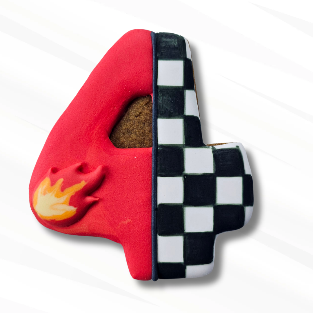 A number 4 sugar cookie featuring a Hot Wheels style design: one half is bright red with a small yellow and orange flame detail, and the other half is a black-and-white checkered pattern. 