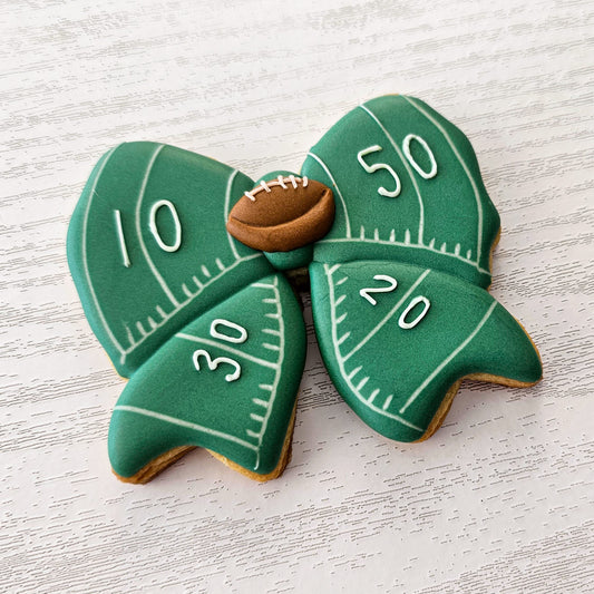 Football bow decorated sugar cookie