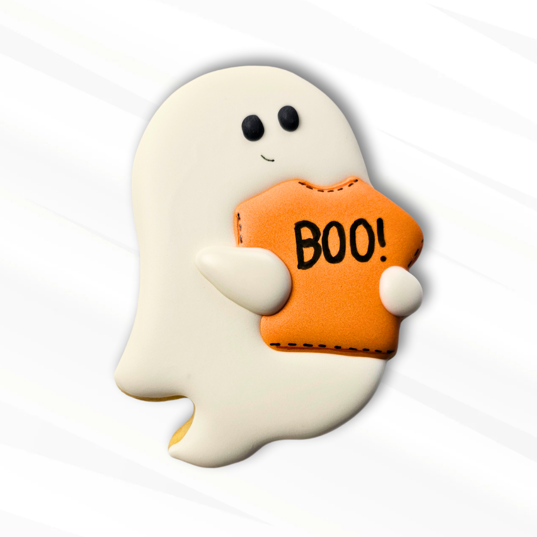 Halloween-themed ghost sugar cookie with an orange shirt displaying 'BOO!' on a white background