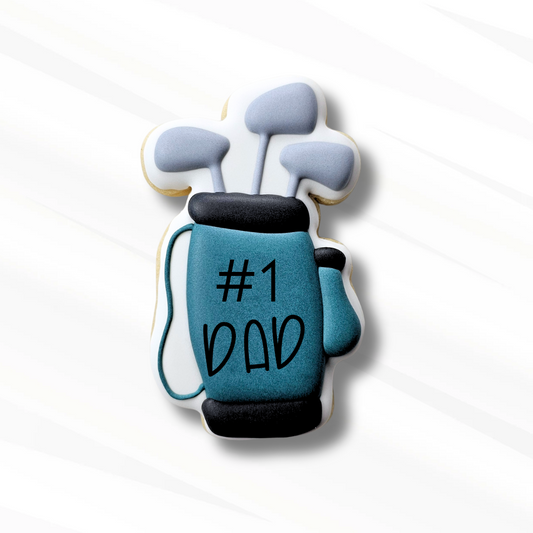 Cookie shaped like a golf bag with 'Number 1 Dad' text on a white background
