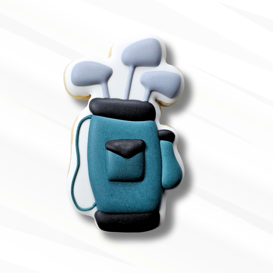 Cookie shaped like a blue golf bag with gray clubs on a white background