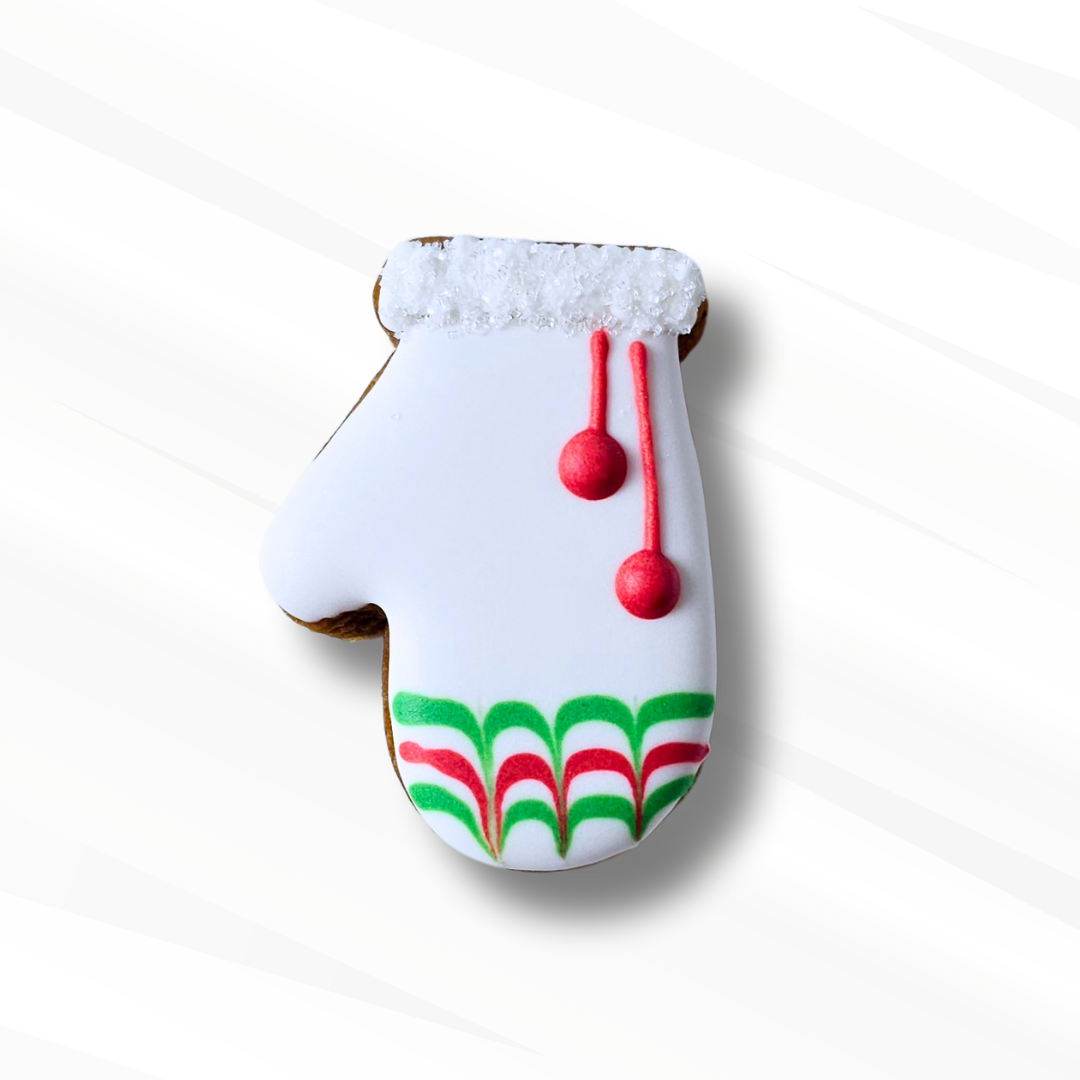 Decorative cookie shaped like a mitten with a red and green pattern on a white background