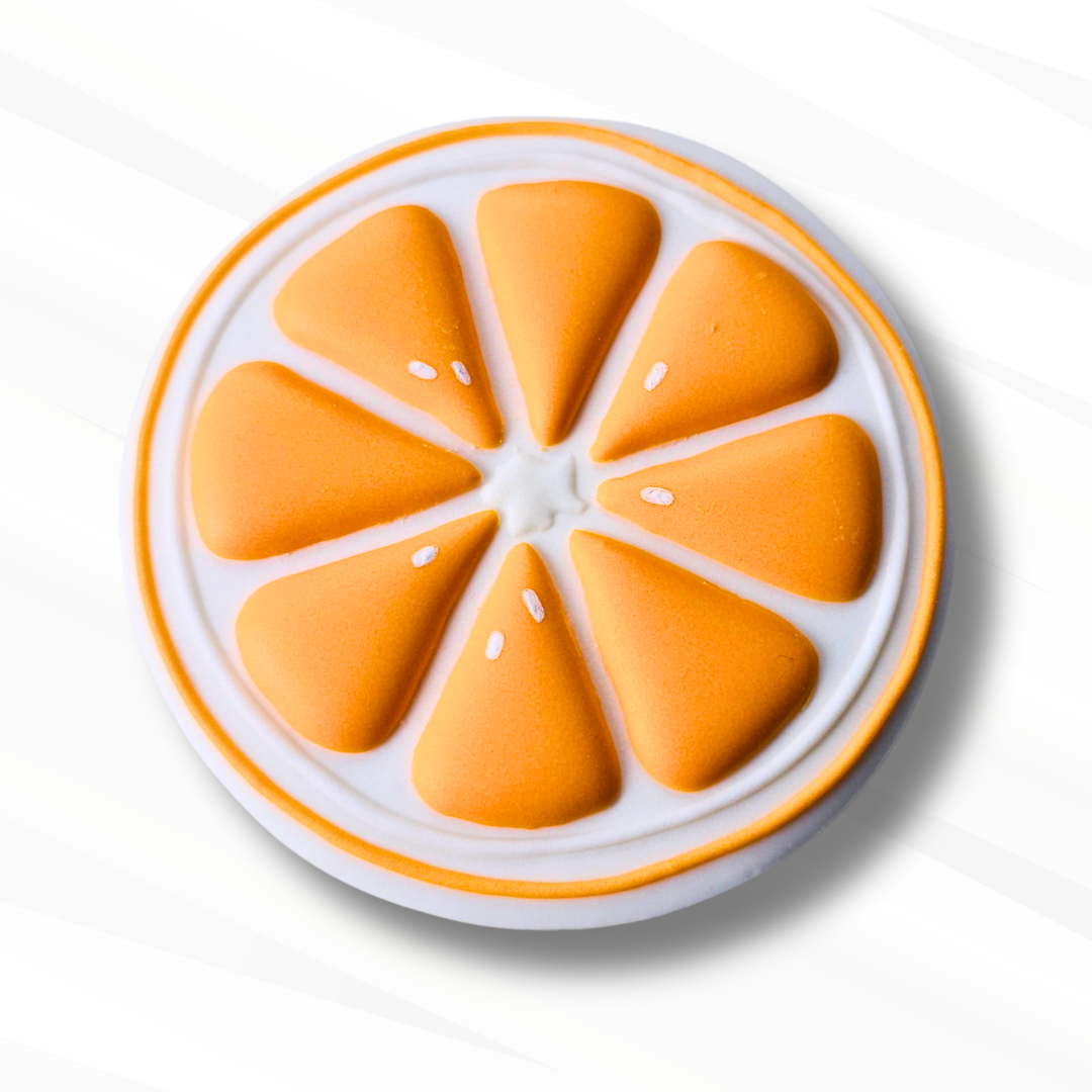 An orange slice sugar cookie featuring textured orange segments on a white base with a thin orange rim, set against a light gray background.