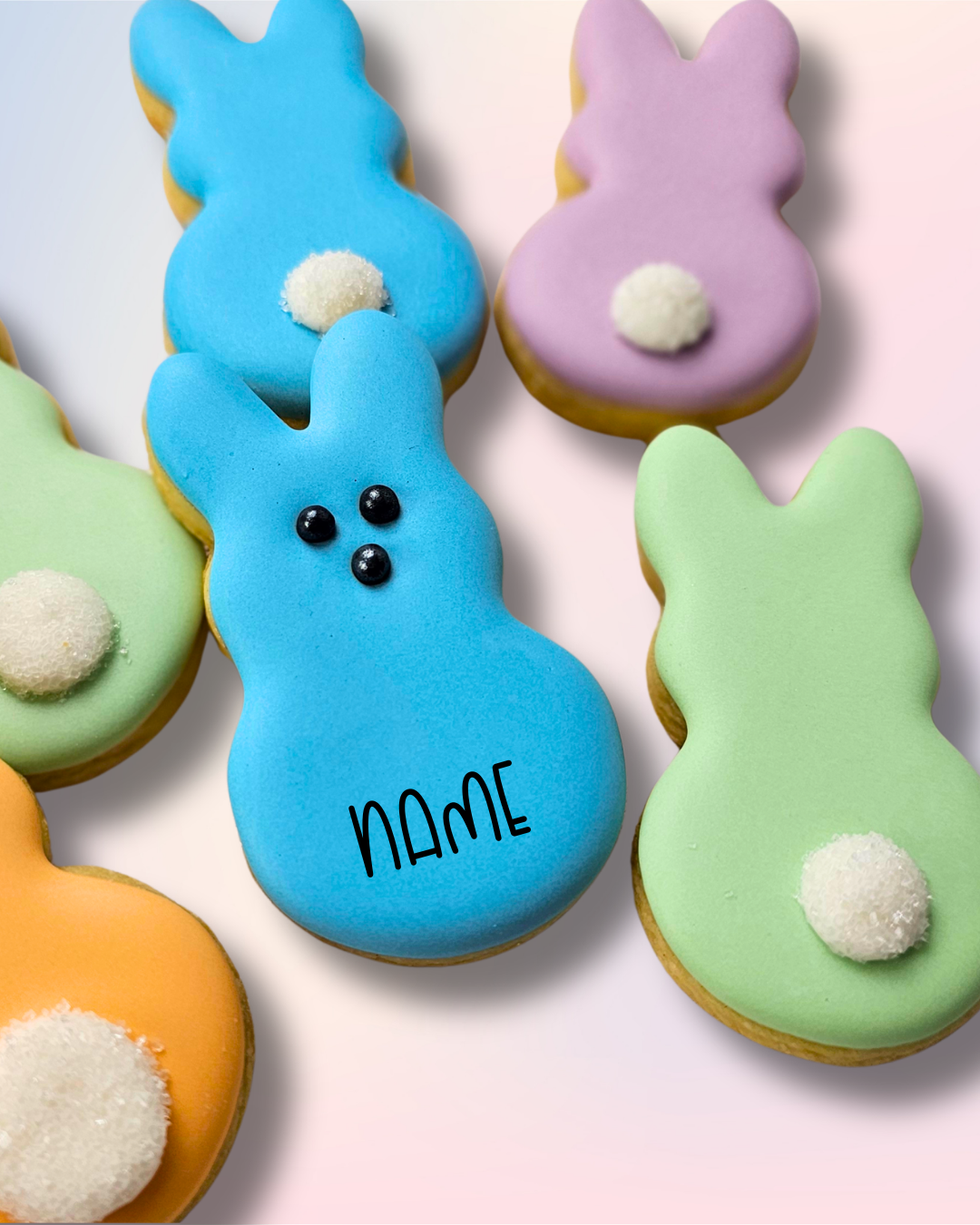 Colorful bunny-shaped peeps sugar cookies on a white background