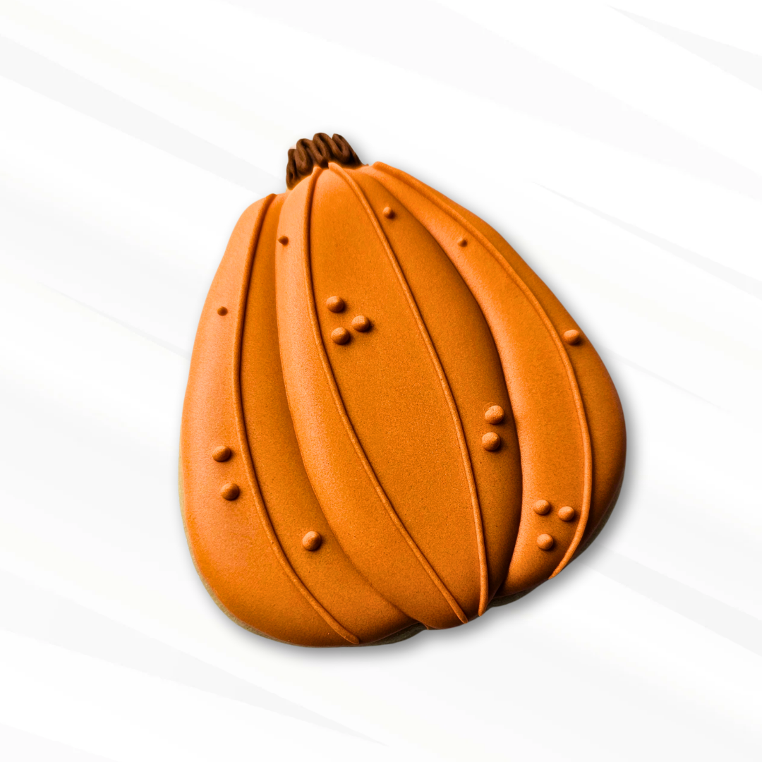 Orange pumpkin sugar cookie on a white background 