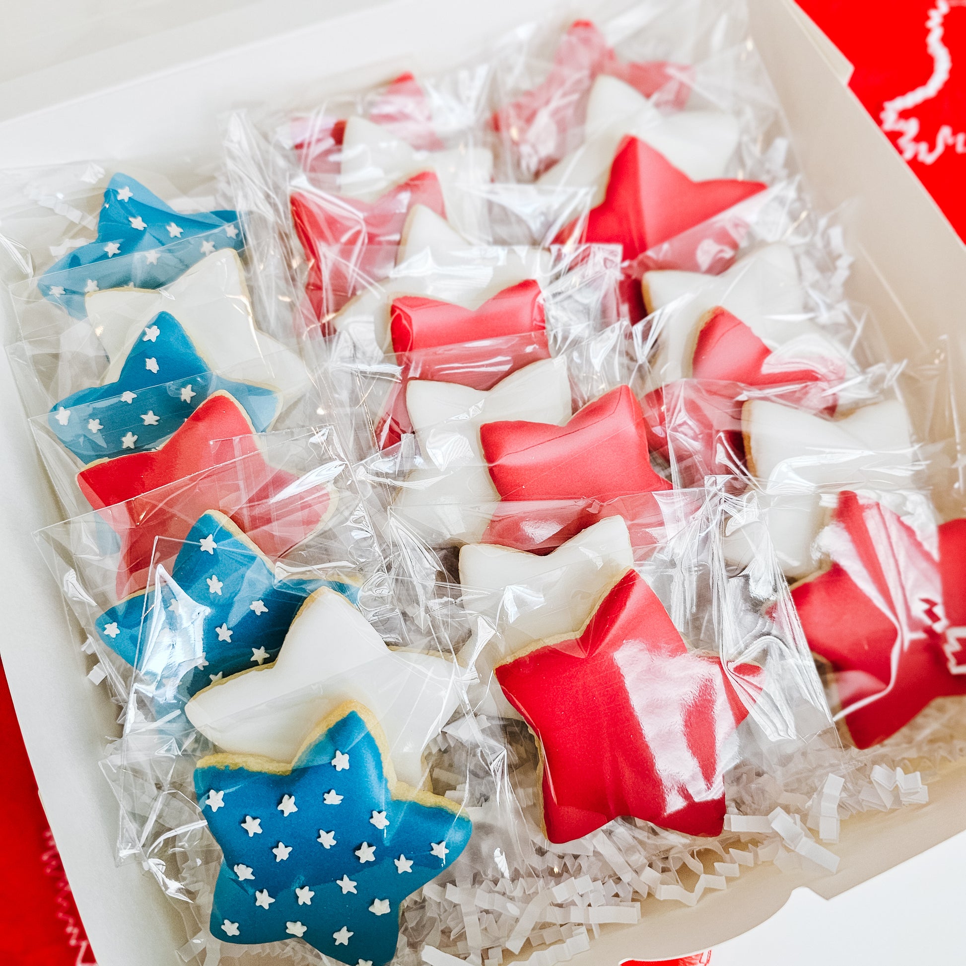 Red white and blue star shaped sugar cookies in a gift box