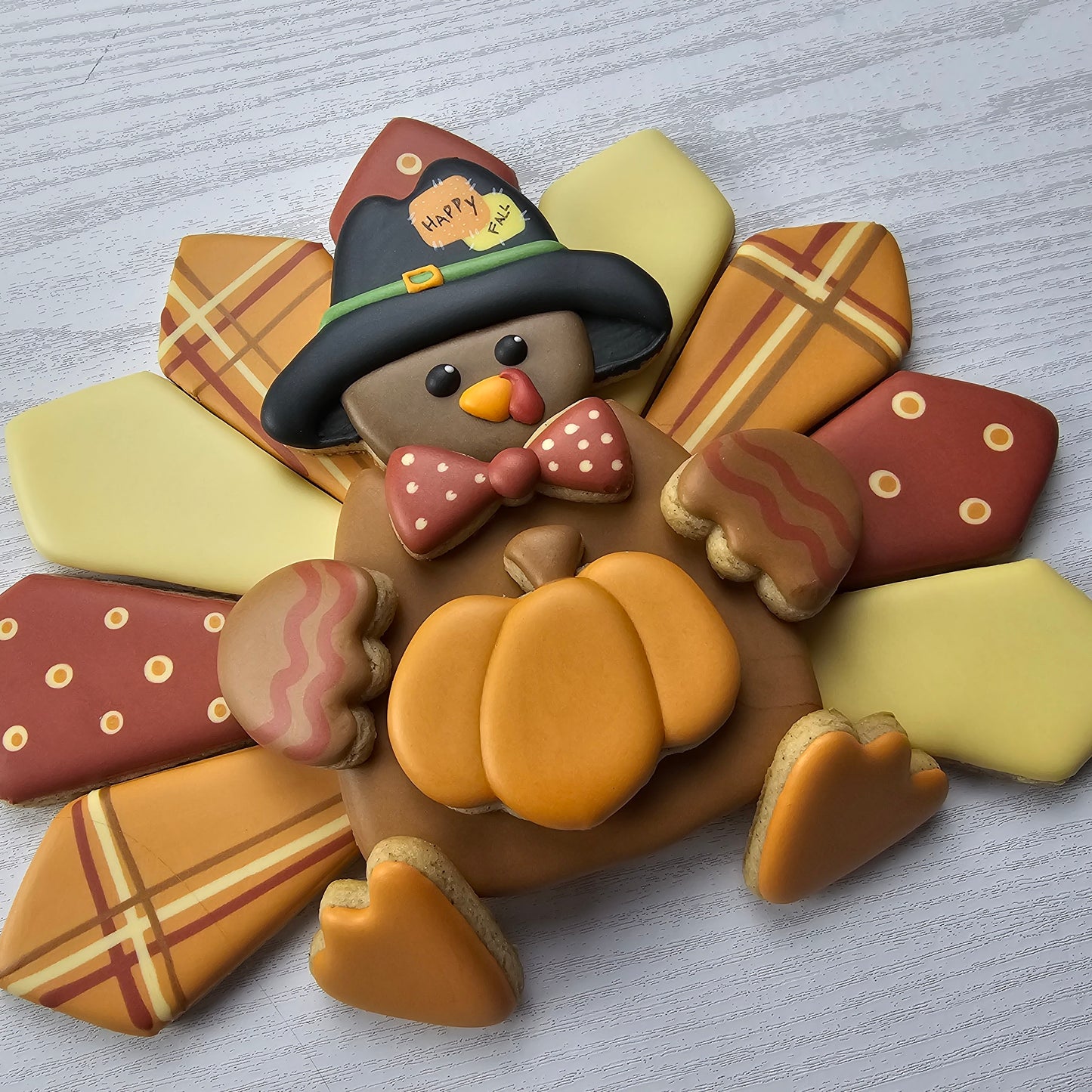 Decorative sugar cookie platter of a turkey with a pilgrim hat on a light gray background
