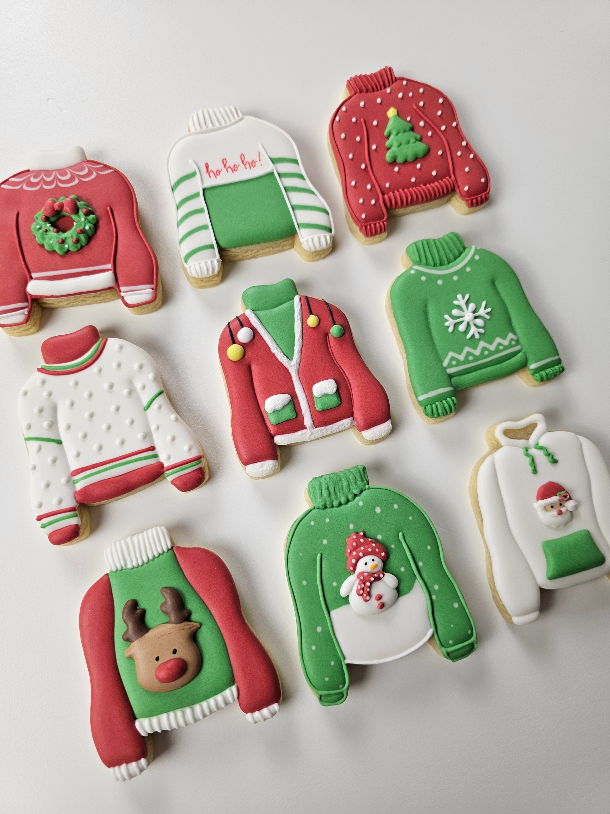 Decorative Christmas cookies shaped like not so ugly sweaters on a white background