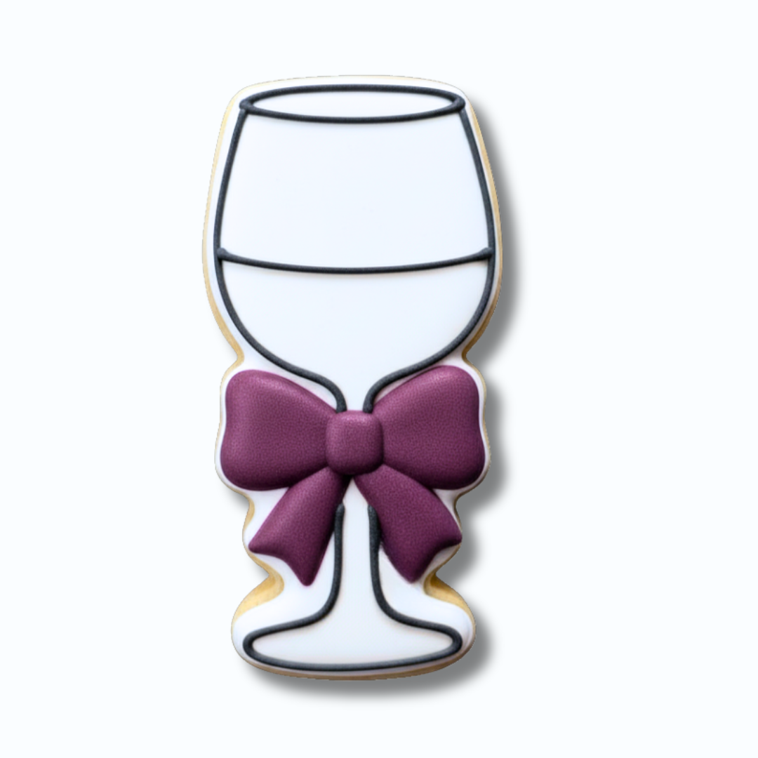 Decorative sugar cookie shaped like a wine glass with a purple bow on a white background
