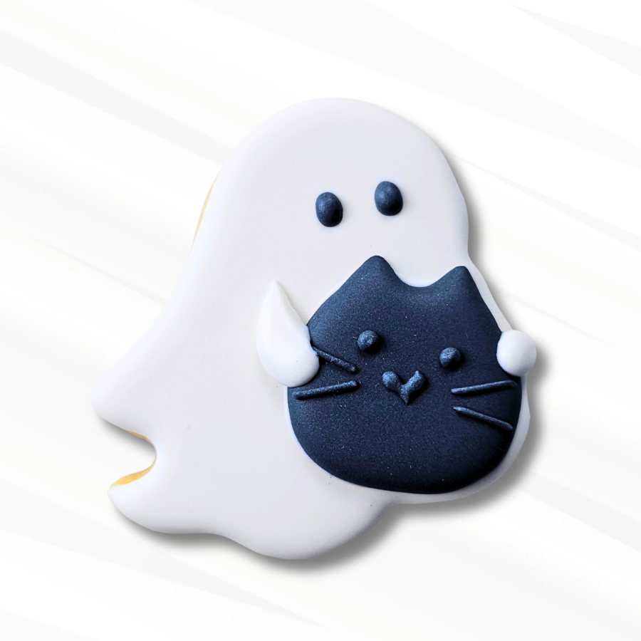 A ghost-shaped white sugar cookie with a black cat shown on a clean white background.