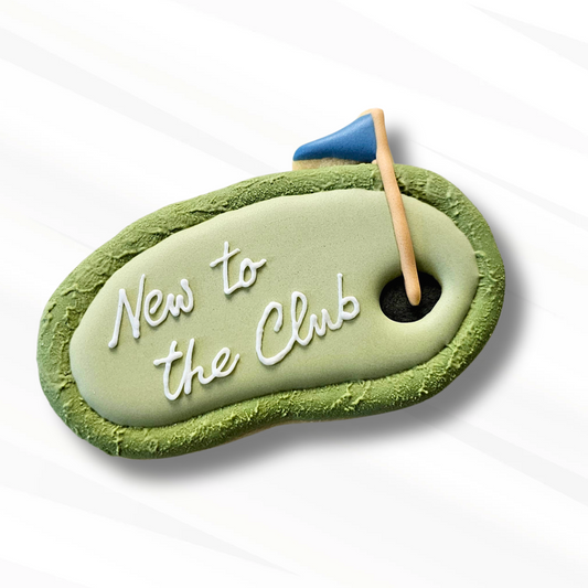 Putting green sugar cookie that says 'New to the Club' on a white background