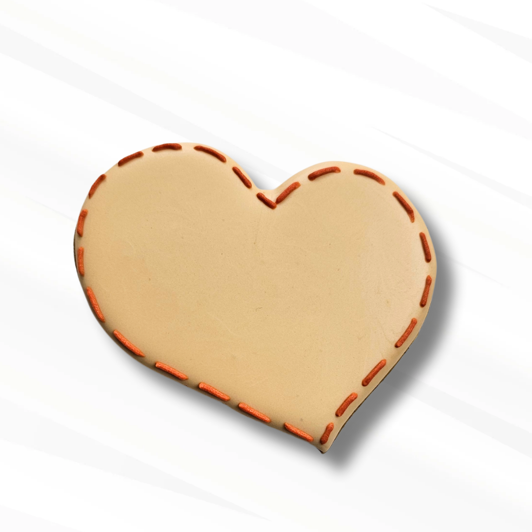 Stitched heart sugar cookie on a white background